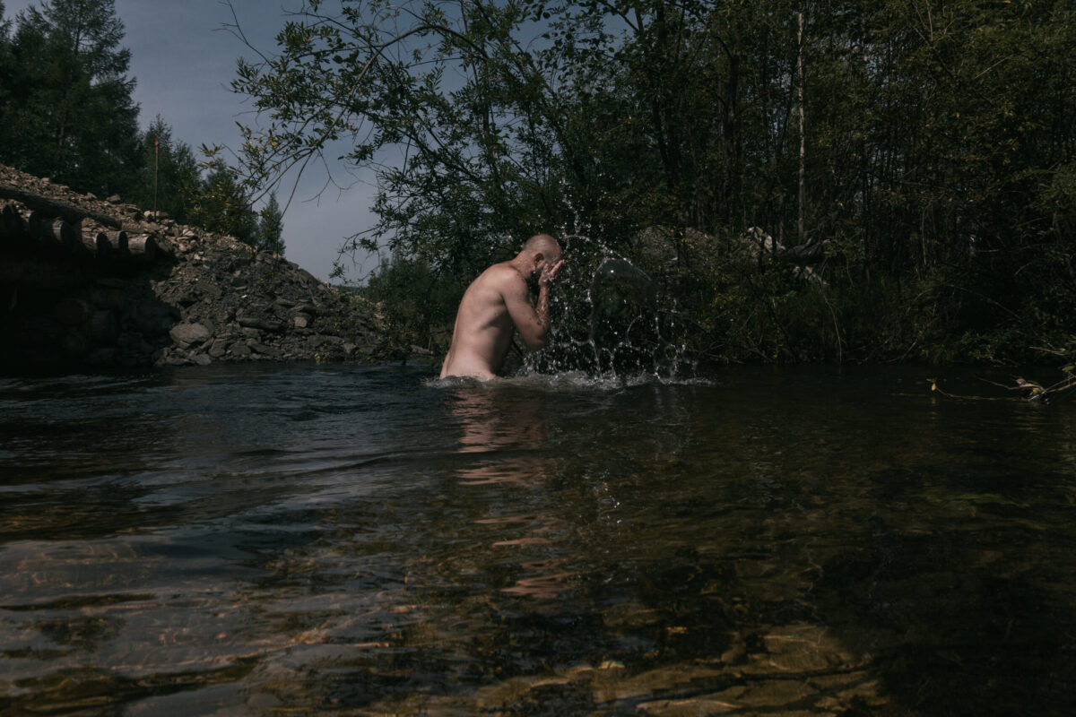 Chegdomyn, Russia. 2022. An Old Believer bathing in a stream.