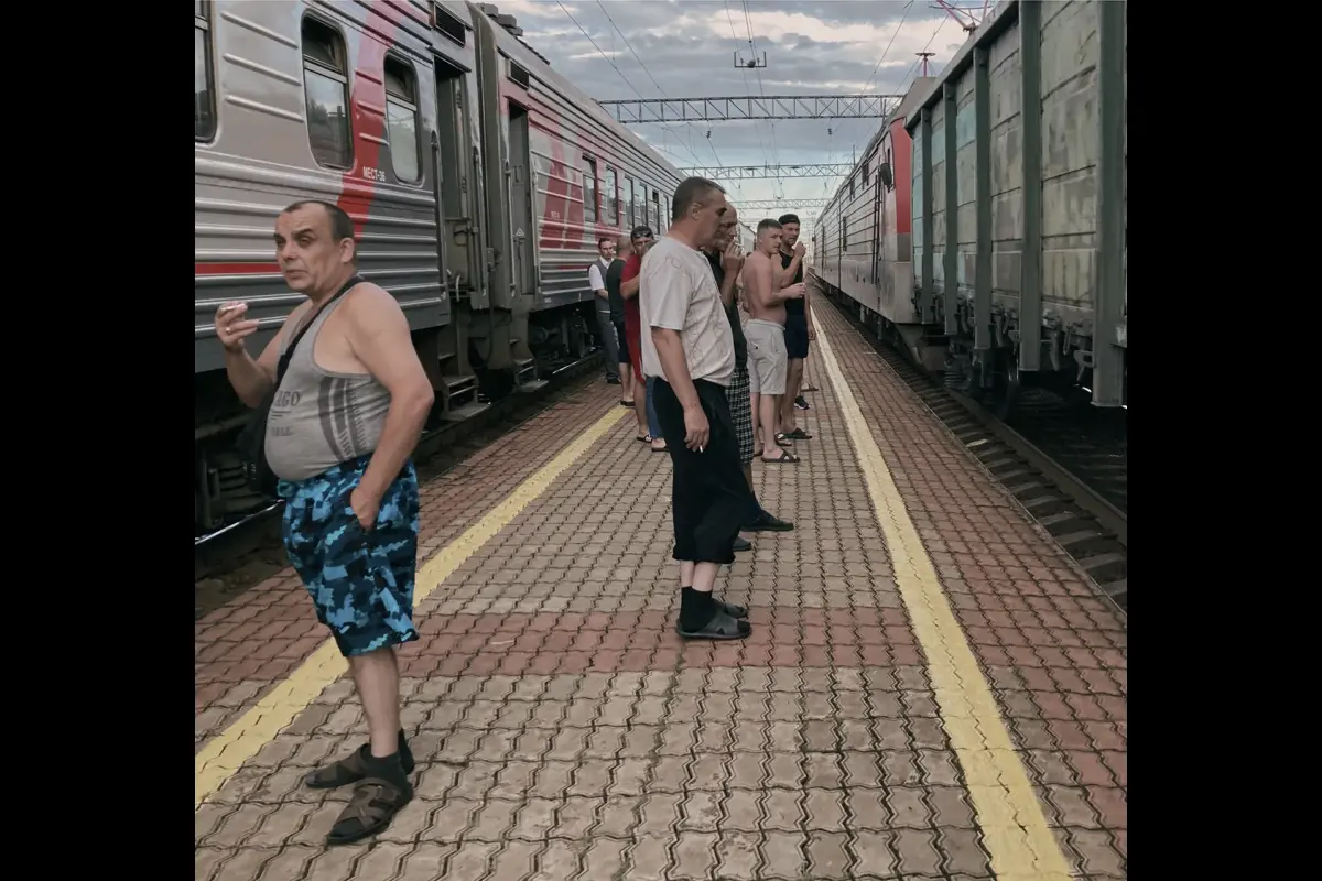Birobidzhan railway station, Russia. Passengers of the train to Chegdomyn have stepped onto the platform.