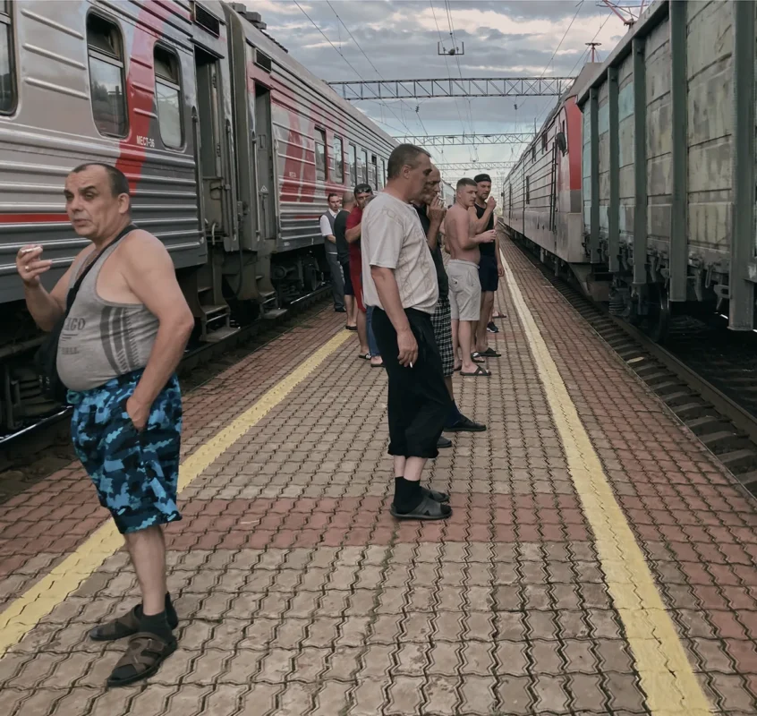 Birobidzhan railway station, Russia. Passengers of the train to Chegdomyn have stepped onto the platform.