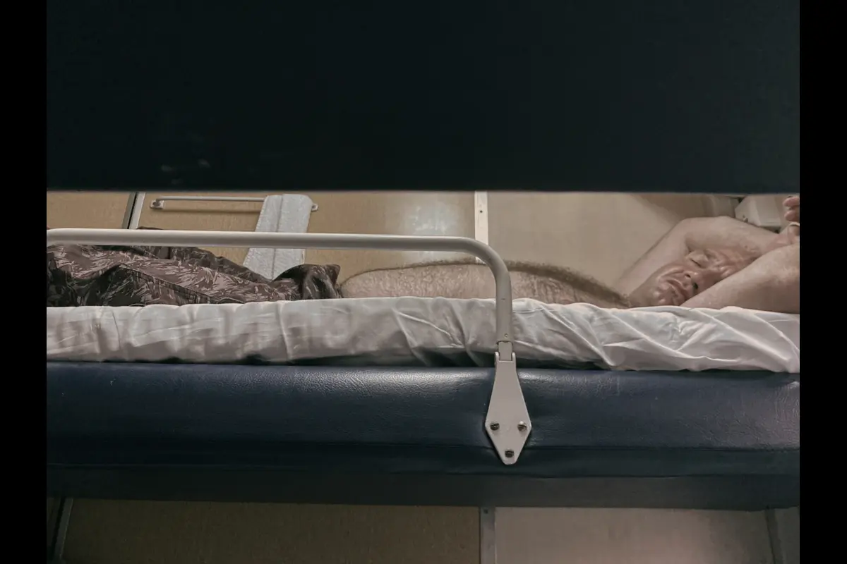 Chegdomyn, Russia. 2022. A rotational worker on the train returning to Khabarovsk after a month-long shift. Such trains often turn into one long vodka bar at the end of a work cycle.