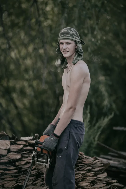 Chegdomyn, Russia. 2019. A young man gathering firewood for the winter.