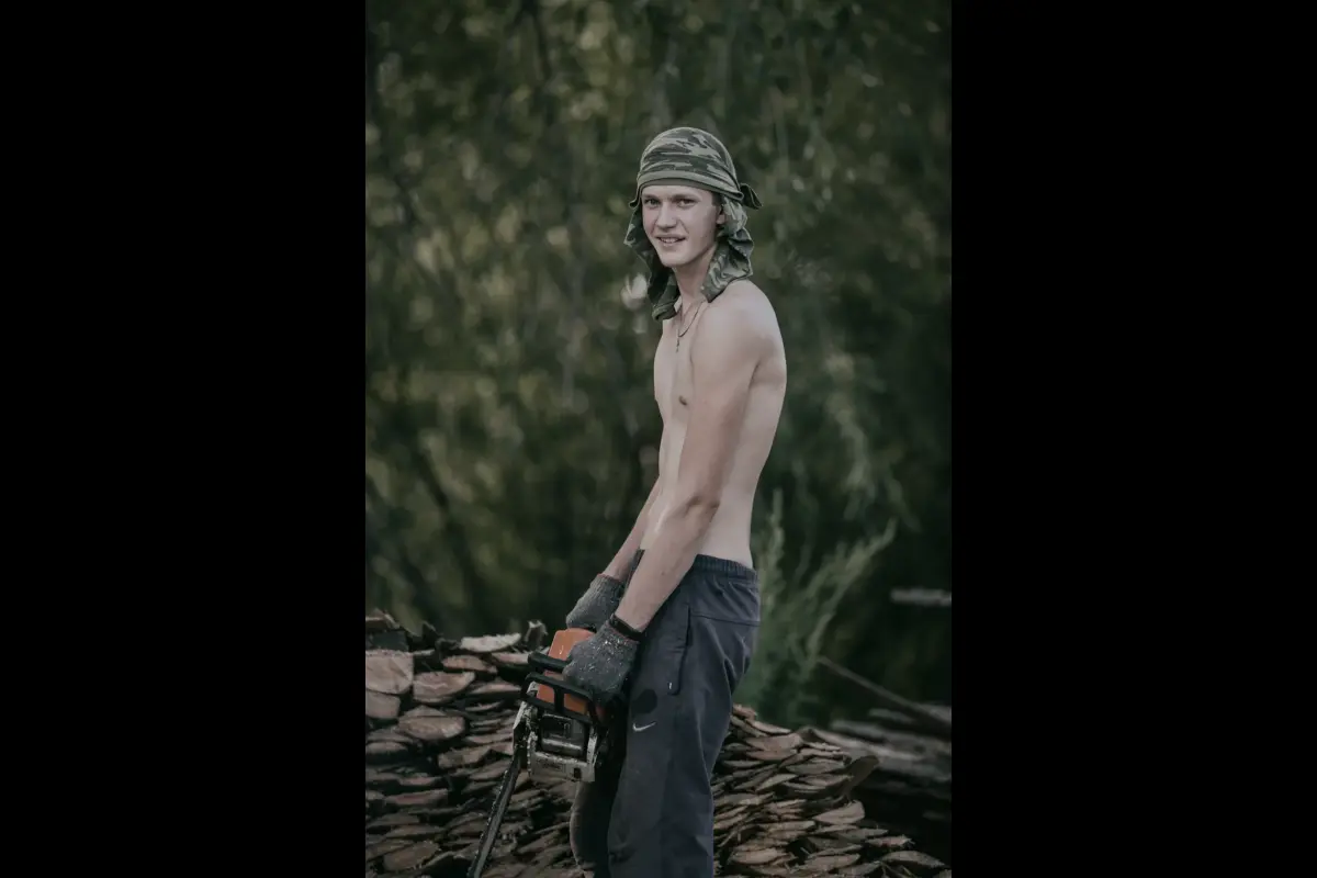 Chegdomyn, Russia. 2019. A young man gathering firewood for the winter.