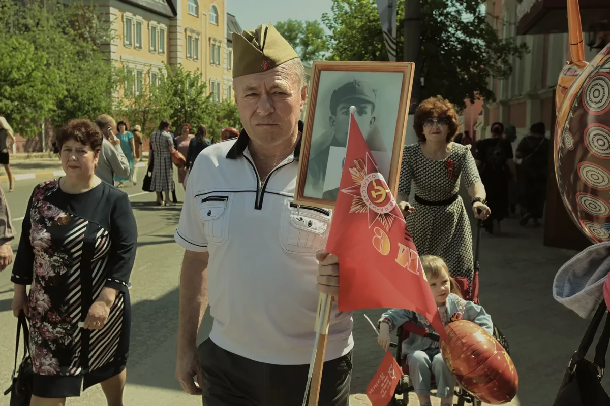 Participant of the “Immortal Regiment” march. The event was first held in 2012 as a one-time civic initiative. It was later turned into an annual state-backed ritual, and the portraits began to expand—from World War II veterans to KGB investigators and even Tsar Nicholas II.