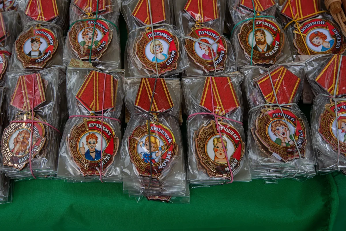 Stalls sell trinkets styled after Soviet World War II military decorations: “To the Best Son-in-Law,” “To the Best Wife,” “To the Lucky Hunter,” “To the Beloved Neighbor,” and so on.