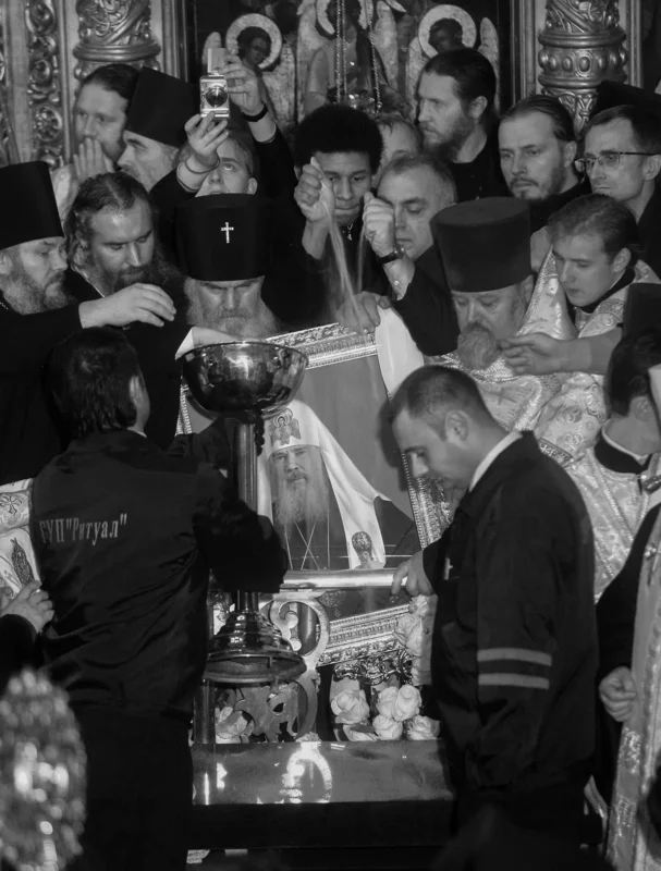 As the coffin of Patriarch Alexy II was being lowered, bishops, priests, and seminarians rushed forward to throw a handful of earth into the open grave. At that moment, a portrait of the late Alexy II nearly fell. In the background is a copy of Andrei Rublev’s icon The Trinity.